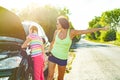 Woman driver with child on country road, near broken car. Royalty Free Stock Photo