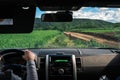 Woman Driver hands on the steering wheel inside of a car, field dirt road, offroad, off road, vrong turn, navigation lost, Royalty Free Stock Photo