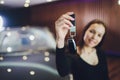 Woman Driver Holding Car Keys. Car Showroom. Royalty Free Stock Photo