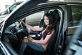 Woman driver sitting in new car buying in showroom Royalty Free Stock Photo