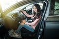 Woman driver sitting in new car buying in showroom Royalty Free Stock Photo