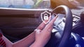 Woman driver holding smartphone with shield protection icon in car, Security shield Lock Security, Protect Concept display, secure Royalty Free Stock Photo