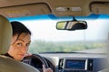 Woman driver looking into rear seat Royalty Free Stock Photo