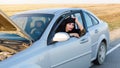 Woman driver sits in the salon of her broken car