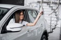 The woman driver smiling showing new car keys Royalty Free Stock Photo