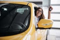 The woman driver smiling showing new car keys Royalty Free Stock Photo