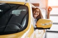 The woman driver smiling showing new car keys Royalty Free Stock Photo