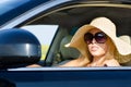 Woman driver in sunhat and sunglasses