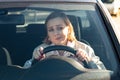 Woman drives her car for the first time, tries to avoid a car accident, is very nervous, scared, worries, clings tightly to the Royalty Free Stock Photo