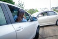 A woman driving a bronze car collides with a gold bronze sedan. Royalty Free Stock Photo