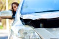 A woman driving a car had an accident parked on the side of the road.