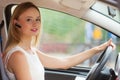 Woman driving car with headset Royalty Free Stock Photo