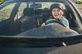 Woman driving car in helmet with horror on her face Royalty Free Stock Photo
