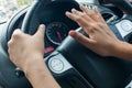 Woman driving car and honking.