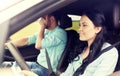 Woman driving car and man covering face with palm Royalty Free Stock Photo