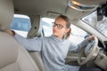 Woman driving a car - parking, going in reverse