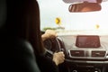 Woman driving car with sign of sharp curves ahead on the road.