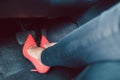 Woman driving a car in an unsafe manner with high-heel shoes