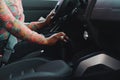 Woman driving. Driver holding hand on transmission and steering wheel. Owner starting her car. Close-up Royalty Free Stock Photo