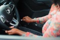 Woman driving. Driver holding hand on transmission and steering wheel. Owner starting her car. Close-up Royalty Free Stock Photo