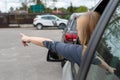 Woman is driving her car very aggressive and gives gesture with his hand finger Royalty Free Stock Photo