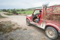 Woman driving a pickup truck with a box full of straw