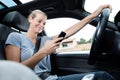 Woman driving and texting on cell phone Royalty Free Stock Photo