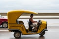 HAVANA, CUBA - OCTOBER 21, 2017: Woman Driving Tuk Tuk Taxi in Havana, Cuba Royalty Free Stock Photo