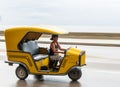 HAVANA, CUBA - OCTOBER 21, 2017: Woman Driving Tuk Tuk Taxi in Havana, Cuba Royalty Free Stock Photo