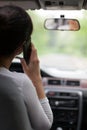 Woman driving and using cell phone Royalty Free Stock Photo