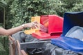 Woman drop plastic bottle into recycle bin.