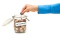 Woman Dropping American Coins into Glass Jar Labeled Retirement Royalty Free Stock Photo