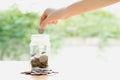 Woman Dropping Coins Into Glass Jar Royalty Free Stock Photo