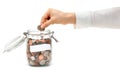 Woman Dropping Coins into Glass Jar Royalty Free Stock Photo