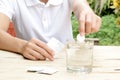 Woman dropping effervescent tablet in glass of water Royalty Free Stock Photo