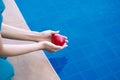 Woman dropping red heart in hands into the water Royalty Free Stock Photo