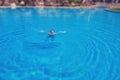 Woman drowns in pool water, tilt shift blurred effect