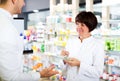 Woman druggist wearing white coat