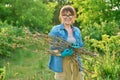 Woman with dry branches of blackcurrant bushes, pruning shears in garden Royalty Free Stock Photo