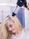 Woman drying hair in bathroom Royalty Free Stock Photo