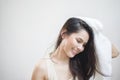 A woman is drying her hair with a towel after showering Royalty Free Stock Photo