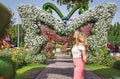 Woman in Dubai Garden portrait. Sunny day beautiful flowers backgrounds Royalty Free Stock Photo