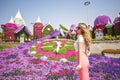 Woman in Dubai Garden portrait. Sunny day beautiful flowers backgrounds