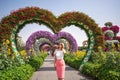 Woman in Dubai Garden portrait. Sunny day beautiful flowers backgrounds Royalty Free Stock Photo