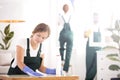 Woman dusting table