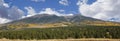 A Woman is Dwarfed by the San Francisco Peaks