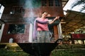 Woman is dyeing cotton with natural materials.