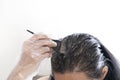 Woman dyeing her hair at home