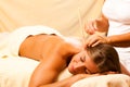 Woman with ear candles and gem massage Royalty Free Stock Photo