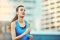 Woman, earphones and running in city, morning and training for exercise, health and speed in street. Girl, person and Royalty Free Stock Photo